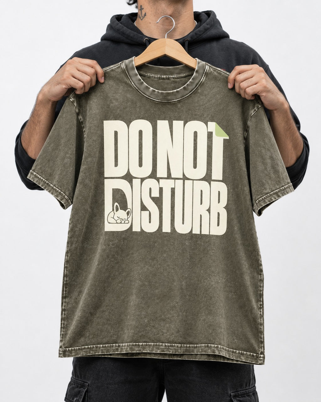 Frenchie Do Not Disturb Hidden Sleeping Graphic Washed Tee in Army Green, held up on a hanger