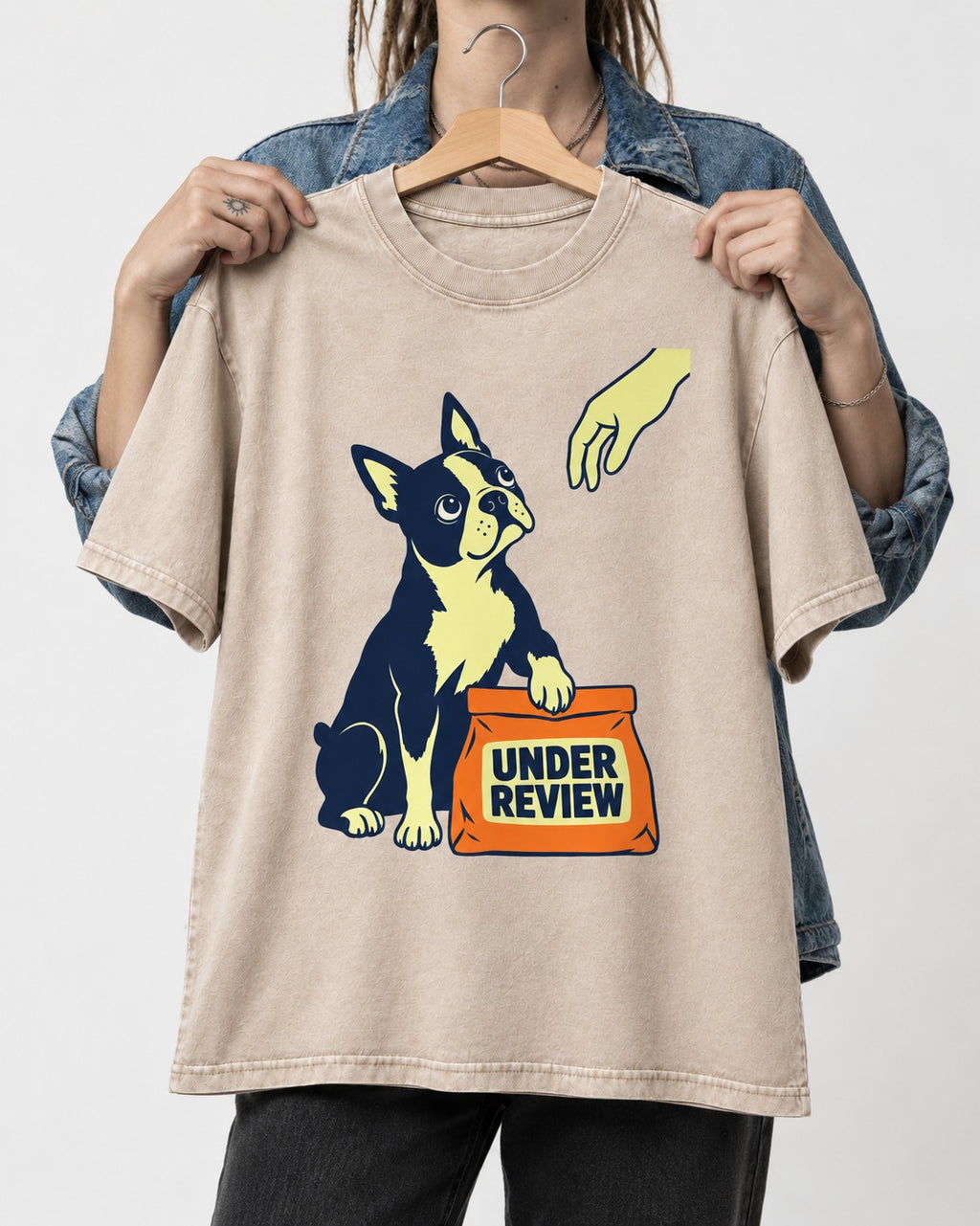 Boston Terrier Under Review Washed Tee in Apricot, held up on a hanger
