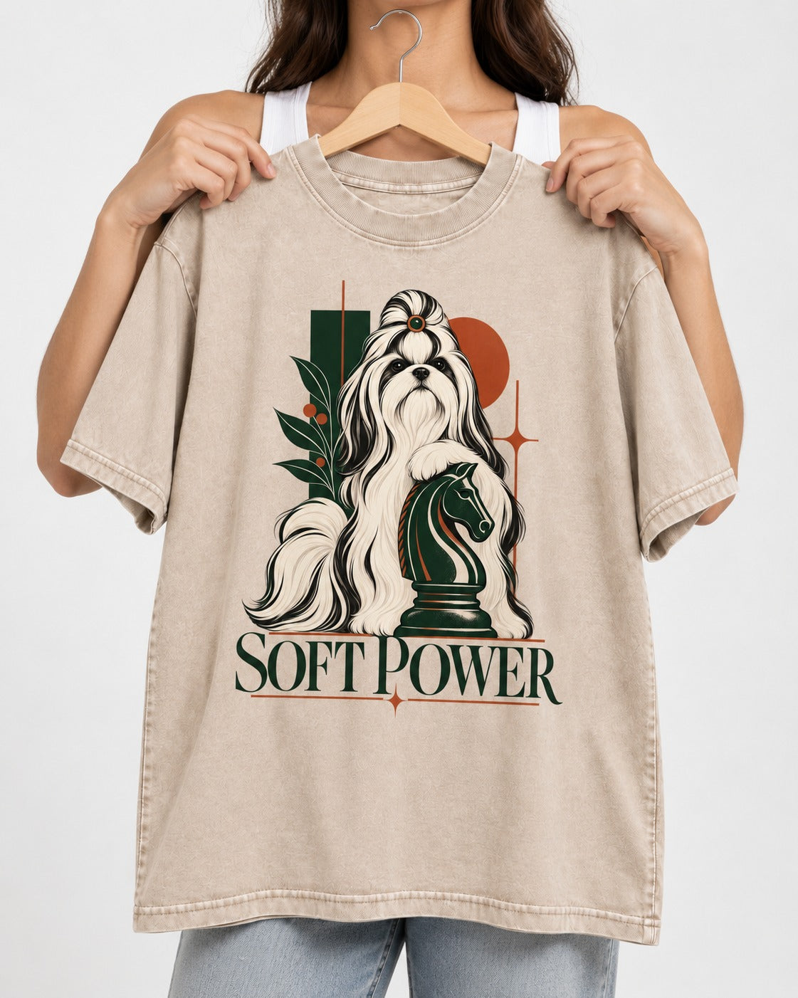 Soft Power Shih Tzu Washed Tee in Apricot, held up on a hanger