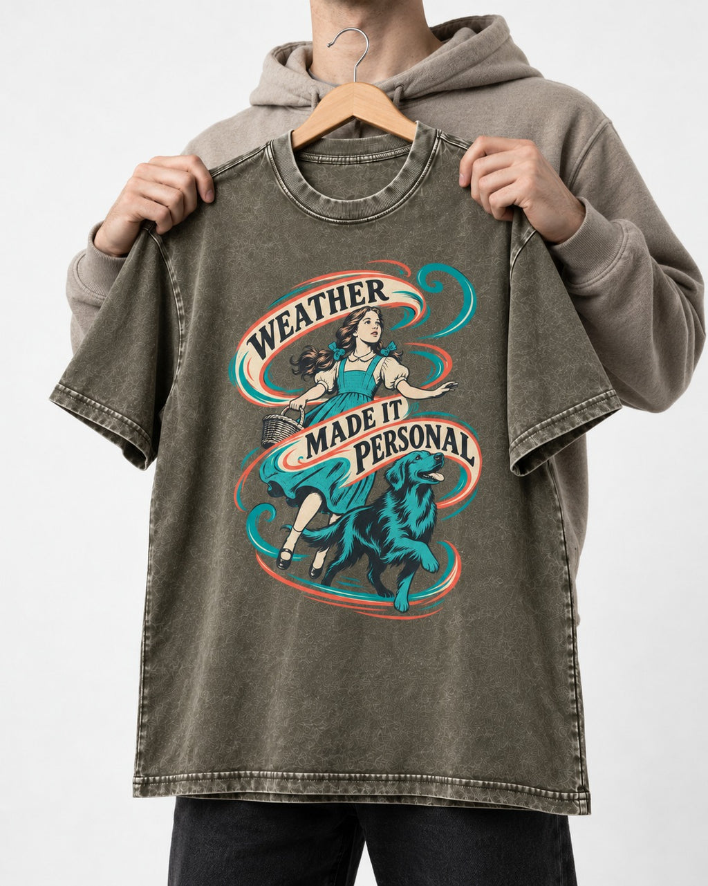 Golden Retriever Weather Made It Personal Woman Graphic Washed Tee in Army Green, held up on a hanger