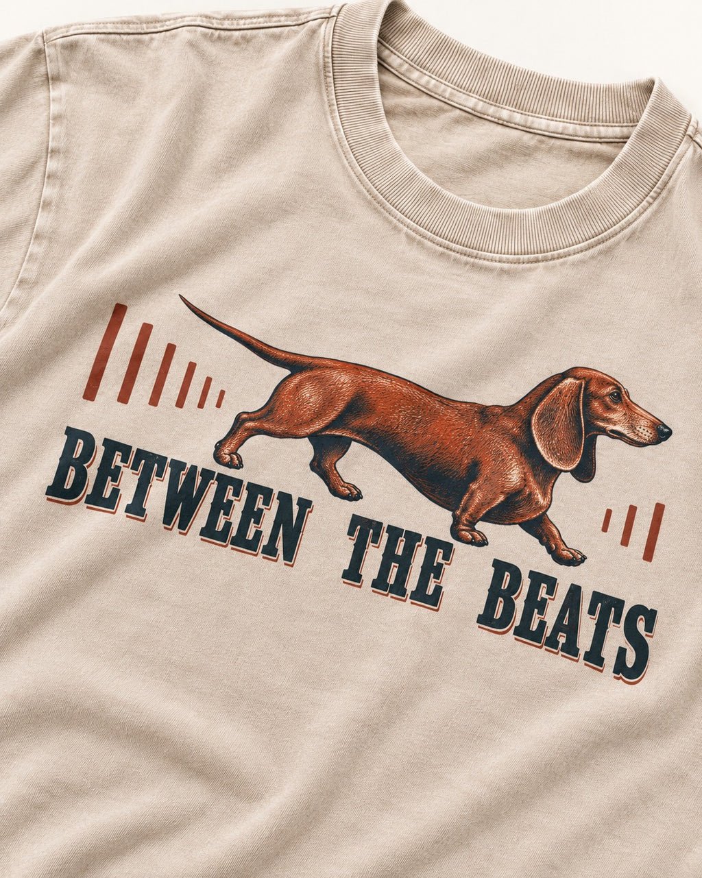 Dachshund Between the Beats Washed Tee in Apricot, close-up of the graphic