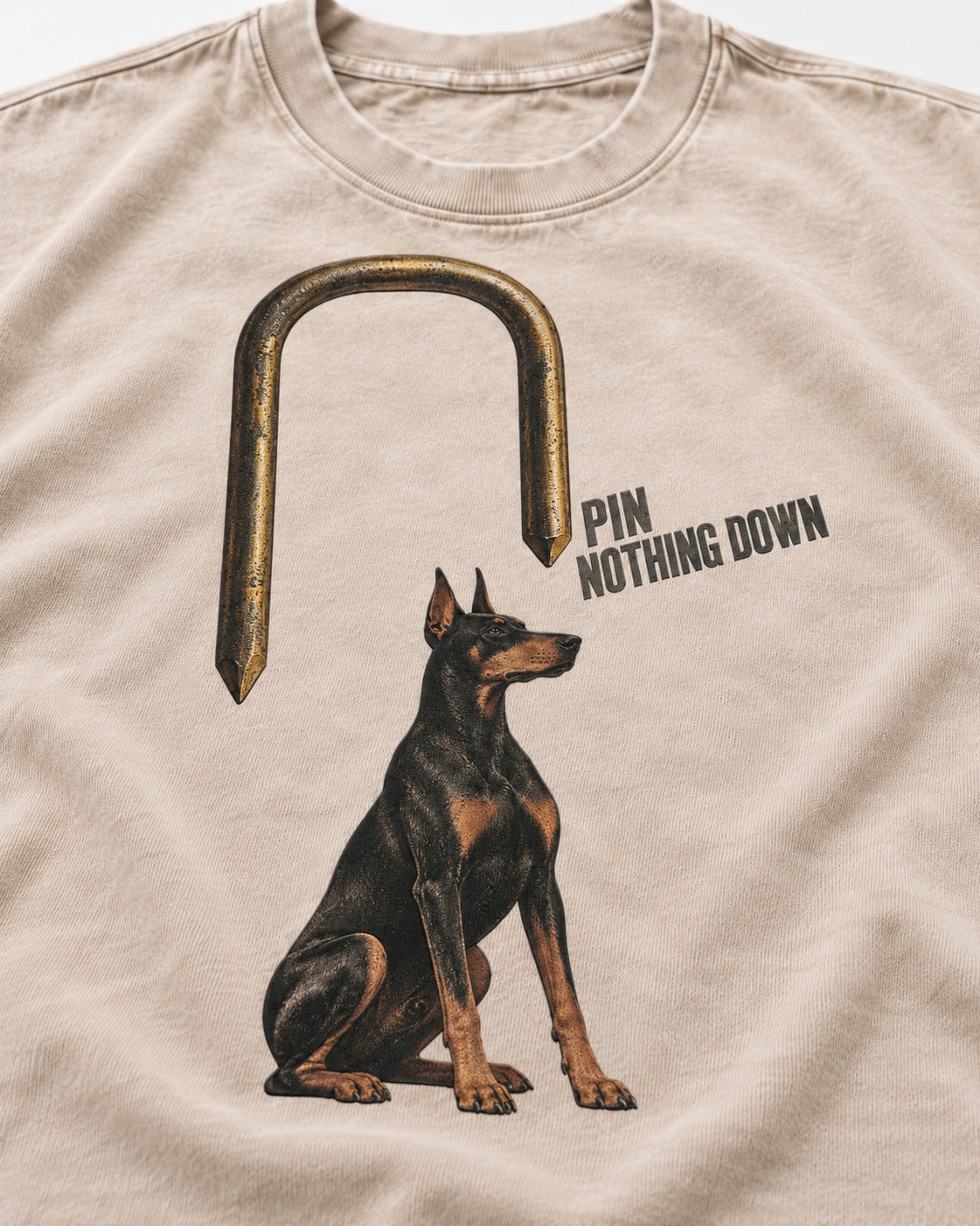 Nothing Pins Doberman Down Washed Tee in Apricot, close-up of the graphic
