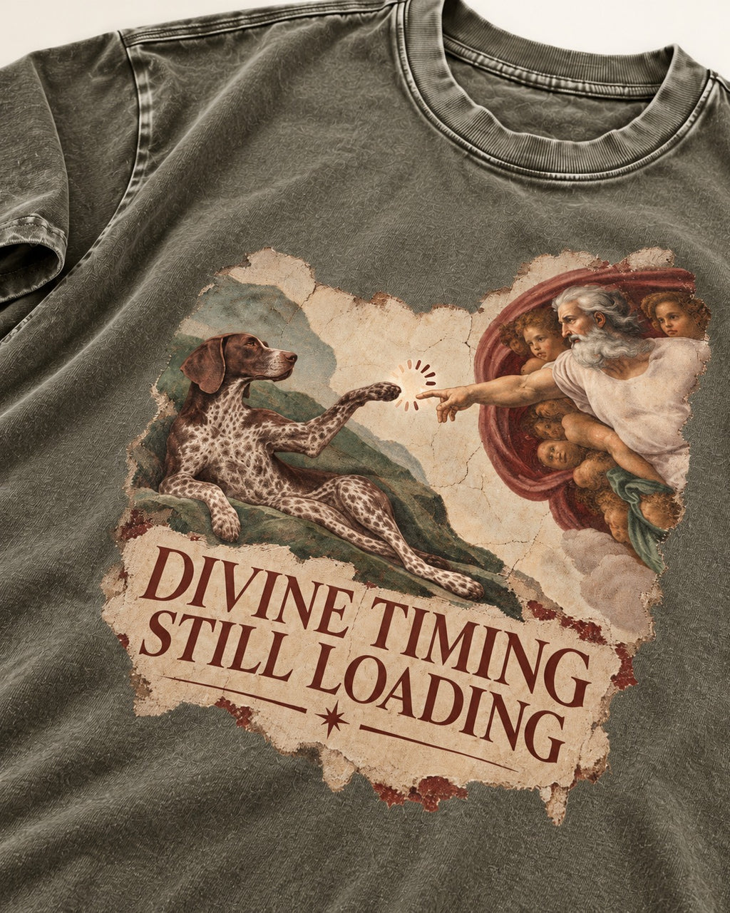 German Shorthaired Pointer Divine Timing Still Loading Creation Scene Graphic Washed Tee in Army Green, close-up of the graphic