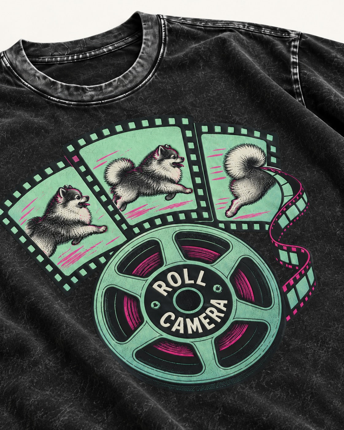 Pomeranian Roll Camera Film Reel Graphic Washed Tee in Black, close-up of the graphic