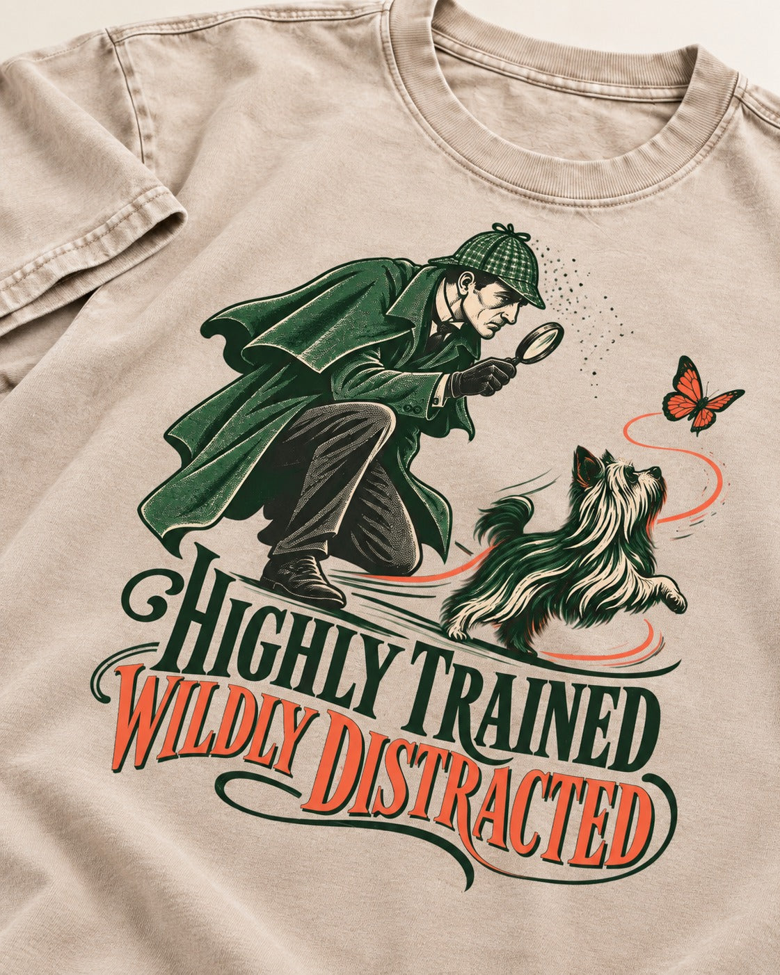 Highly Trained Wildly Distracted Yorkshire Terrier Washed Tee in Apricot, close-up of the graphic