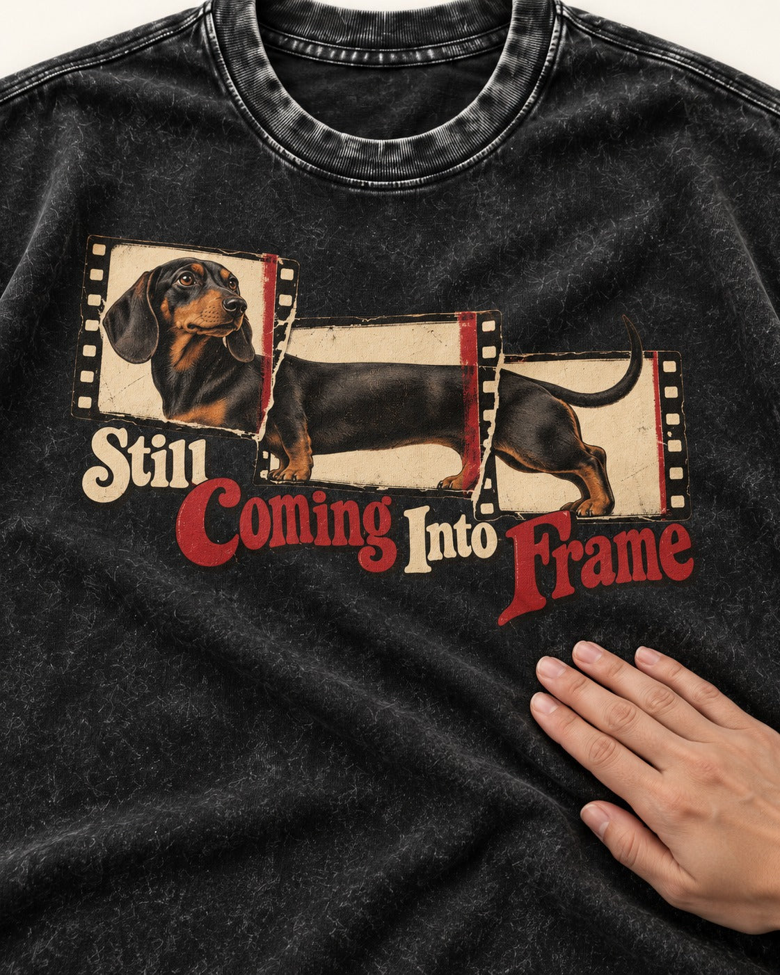 Dachshund Still Coming Into Frame Vintage Filmstrip Graphic Washed Tee in Black, close-up of the graphic