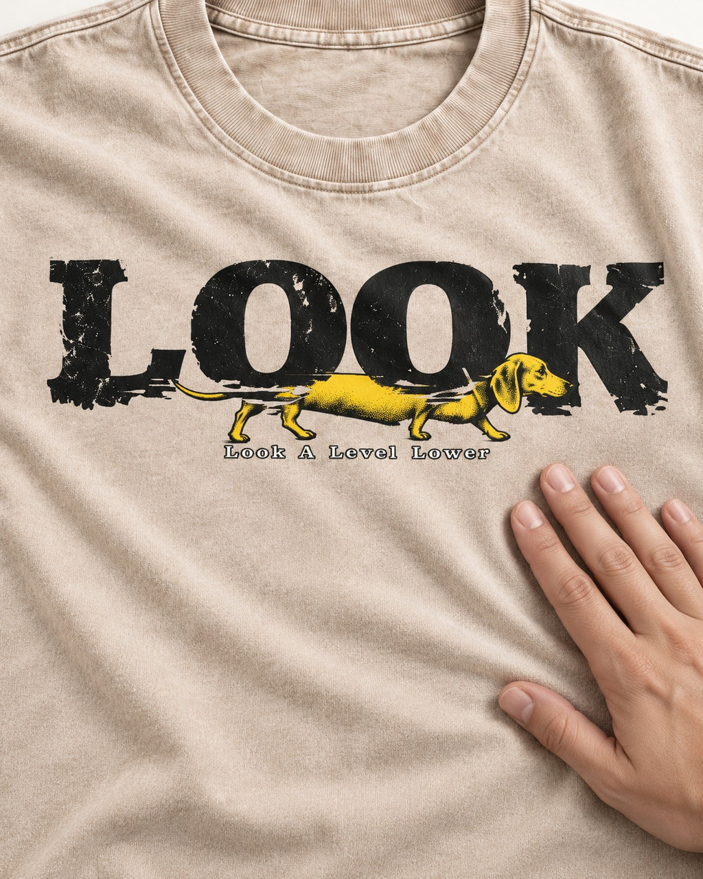 Dachshund Look A Level Lower Typographic Graphic Washed Tee in Apricot, close-up of the graphic
