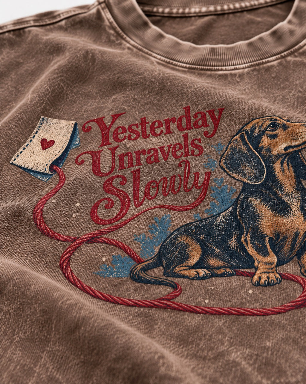 Yesterday Unravels Slowly with Dachshund Washed Tee in Coffee, close-up of the graphic