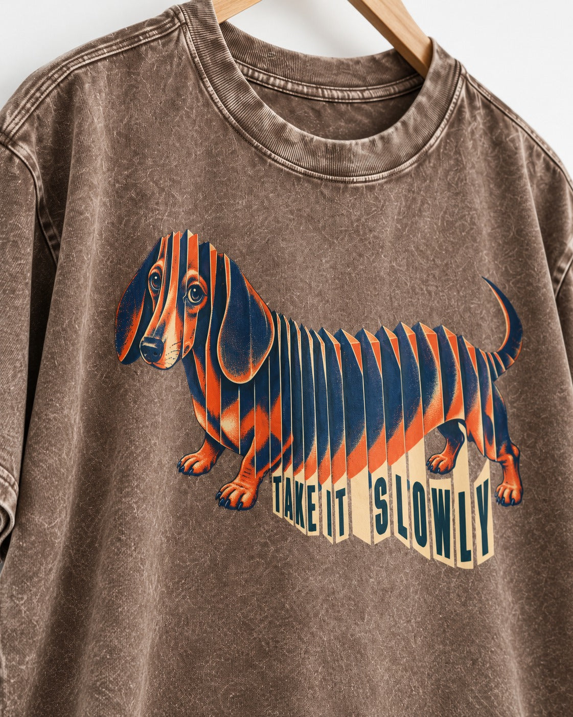 Take It Slowly Dachshund Washed Tee in Coffee, close-up of the graphic