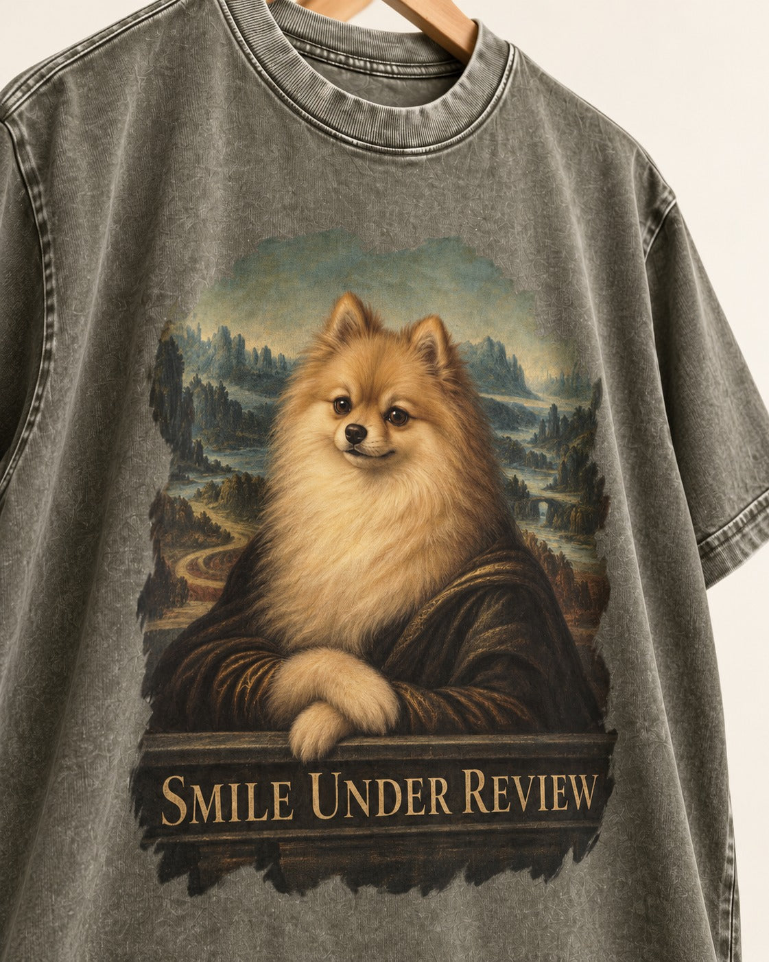 Pomeranian Smile Under Review Renaissance Portrait Graphic Washed Tee in Army Green, close-up of the graphic