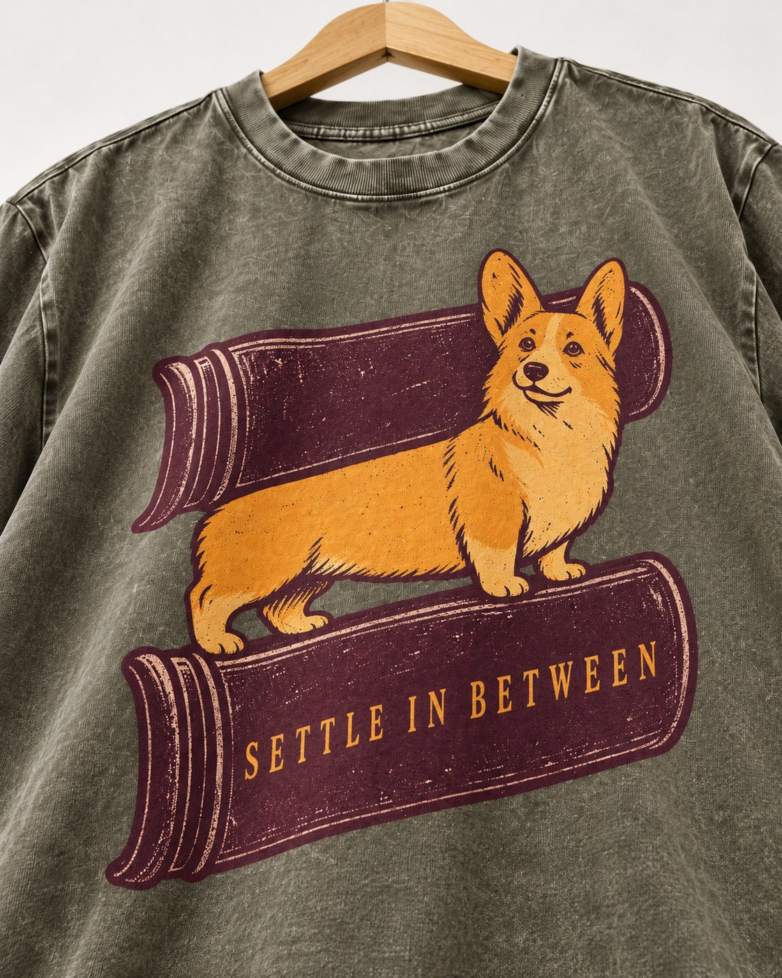 Corgi Settle in Between Washed Tee in Army Green, close-up of the graphic