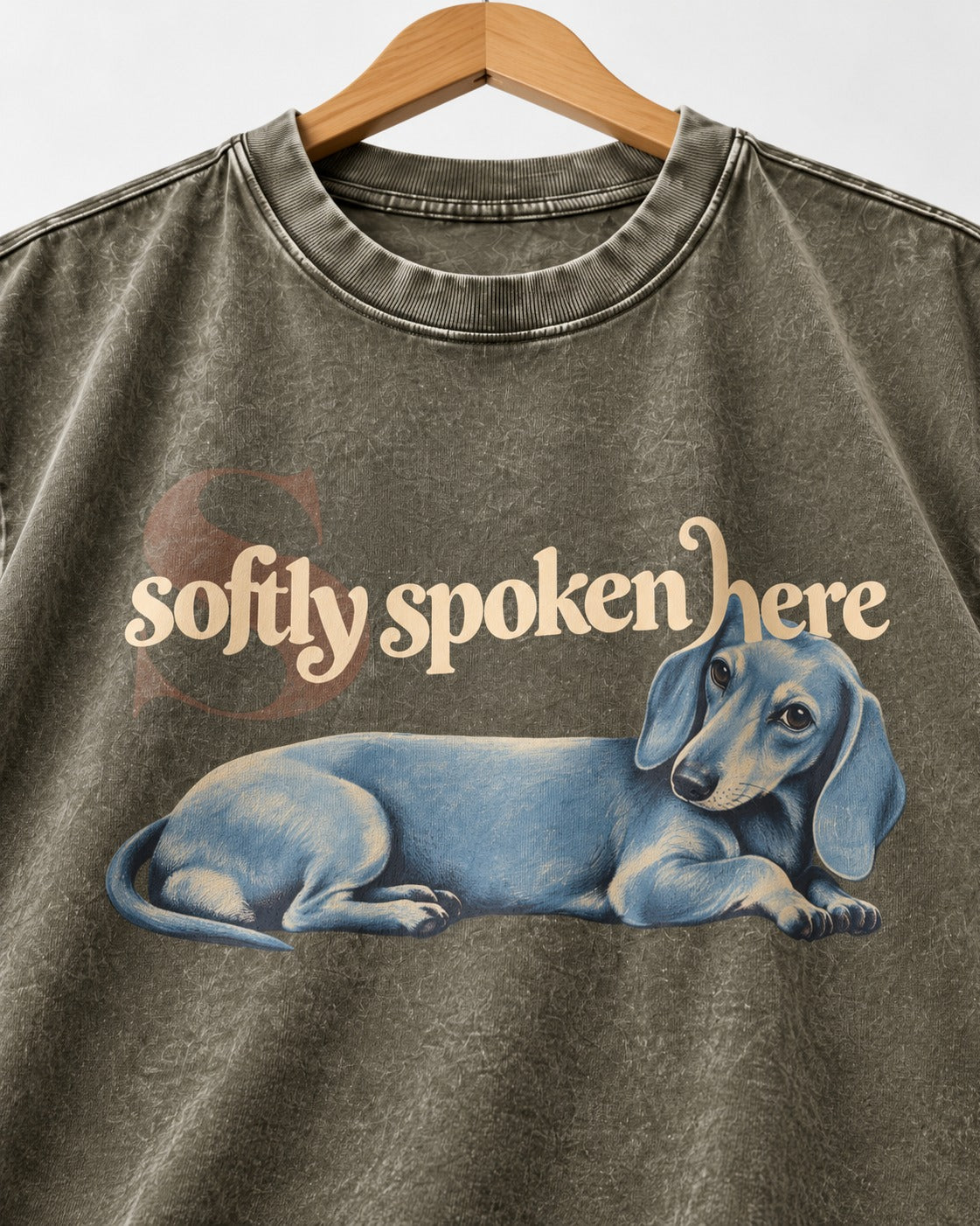 Dachshund Softly Spoken Here Reclining Portrait Graphic Washed Tee in Army Green, close-up of the graphic