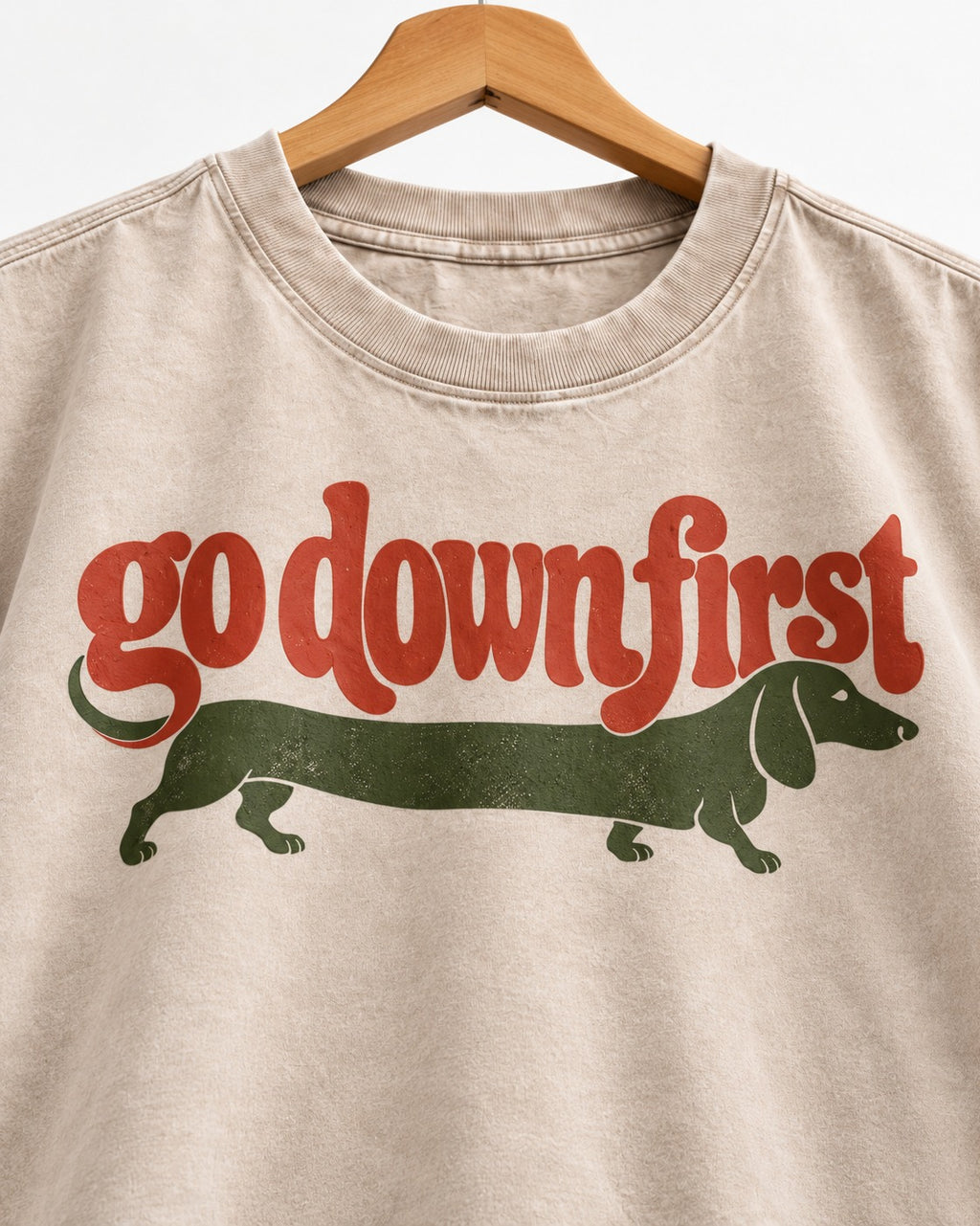 Dachshund Goes Down First Washed Tee in Apricot, close-up of the graphic