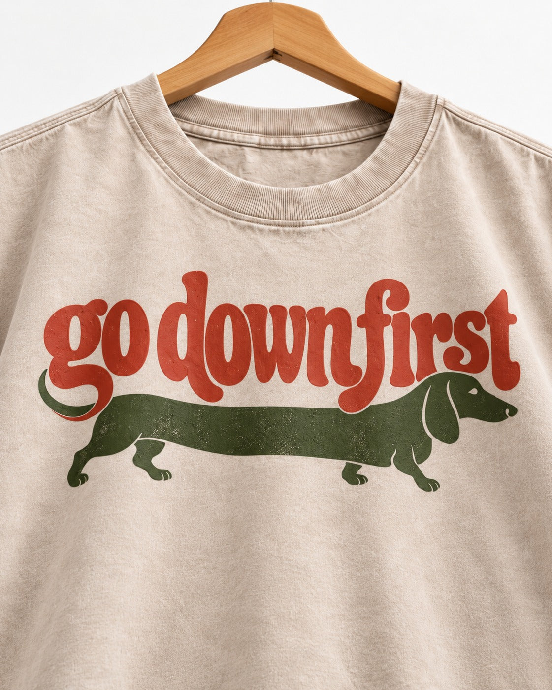 Dachshund Goes Down First Washed Tee in Apricot, close-up of the graphic