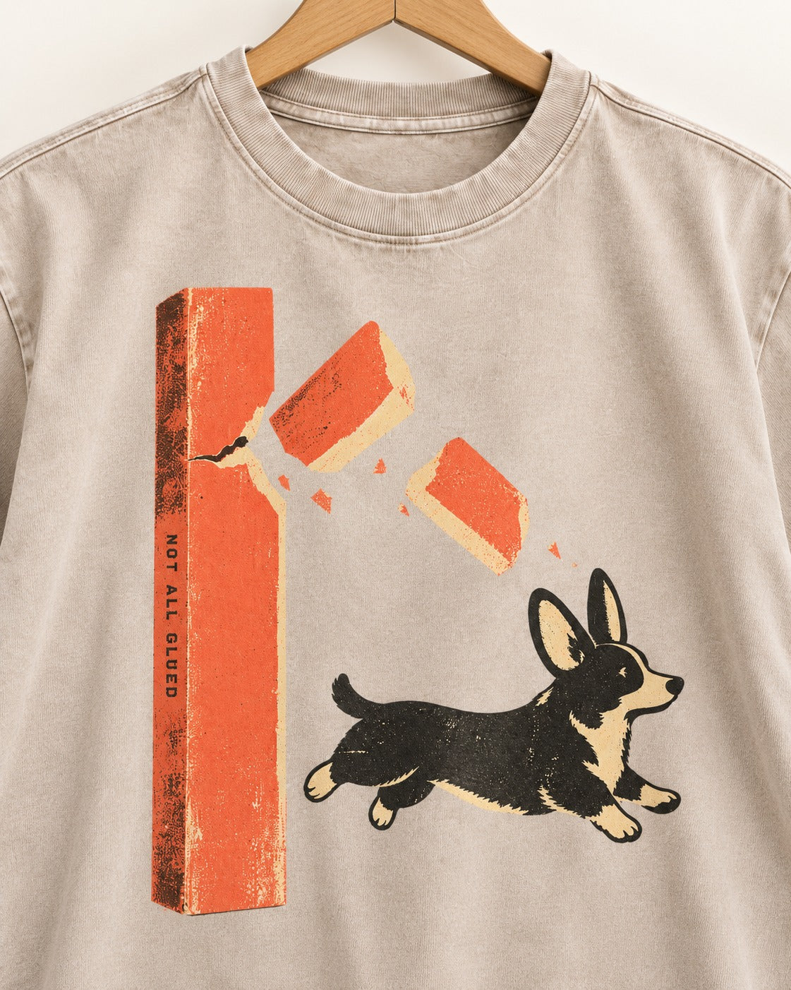 Not All Glued Corgi Washed Tee in Apricot, close-up of the graphic