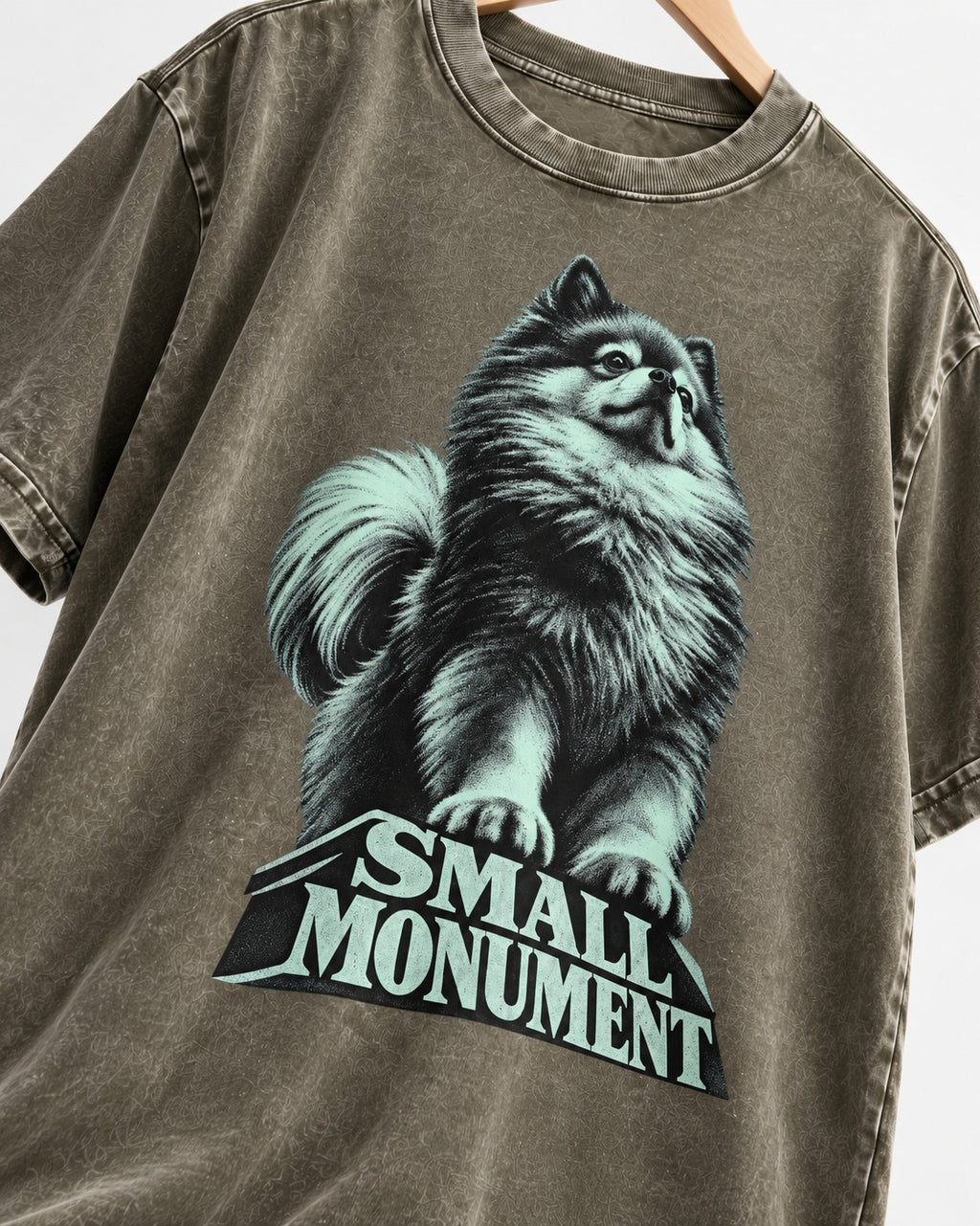 Pomeranian Small Monument Pedestal Graphic Washed Tee in Army Green, close-up of the graphic