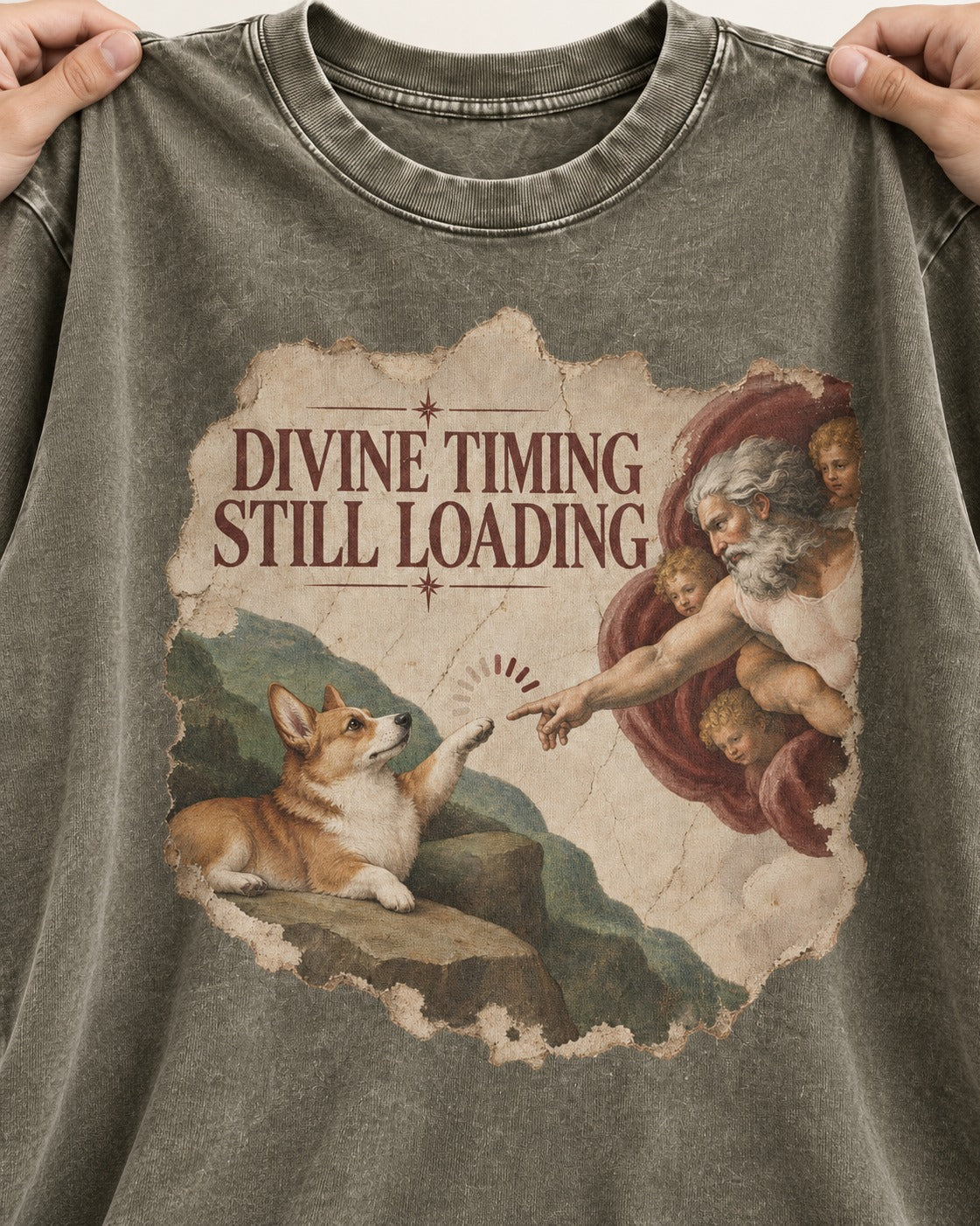 Corgi Divine Timing Still Loading Creation Parody Washed Tee in Army Green, close-up of the graphic