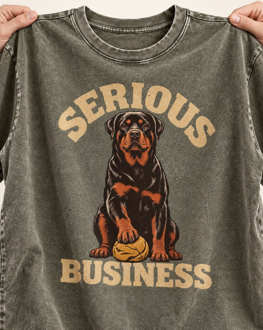 Rottweiler Serious Business Ball Under Paw Graphic Washed Tee in Army Green, close-up of the graphic