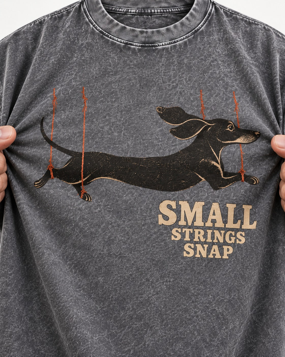 Dachshund Small Strings Snap Marionette Graphic Washed Tee in Gray, close-up of the graphic