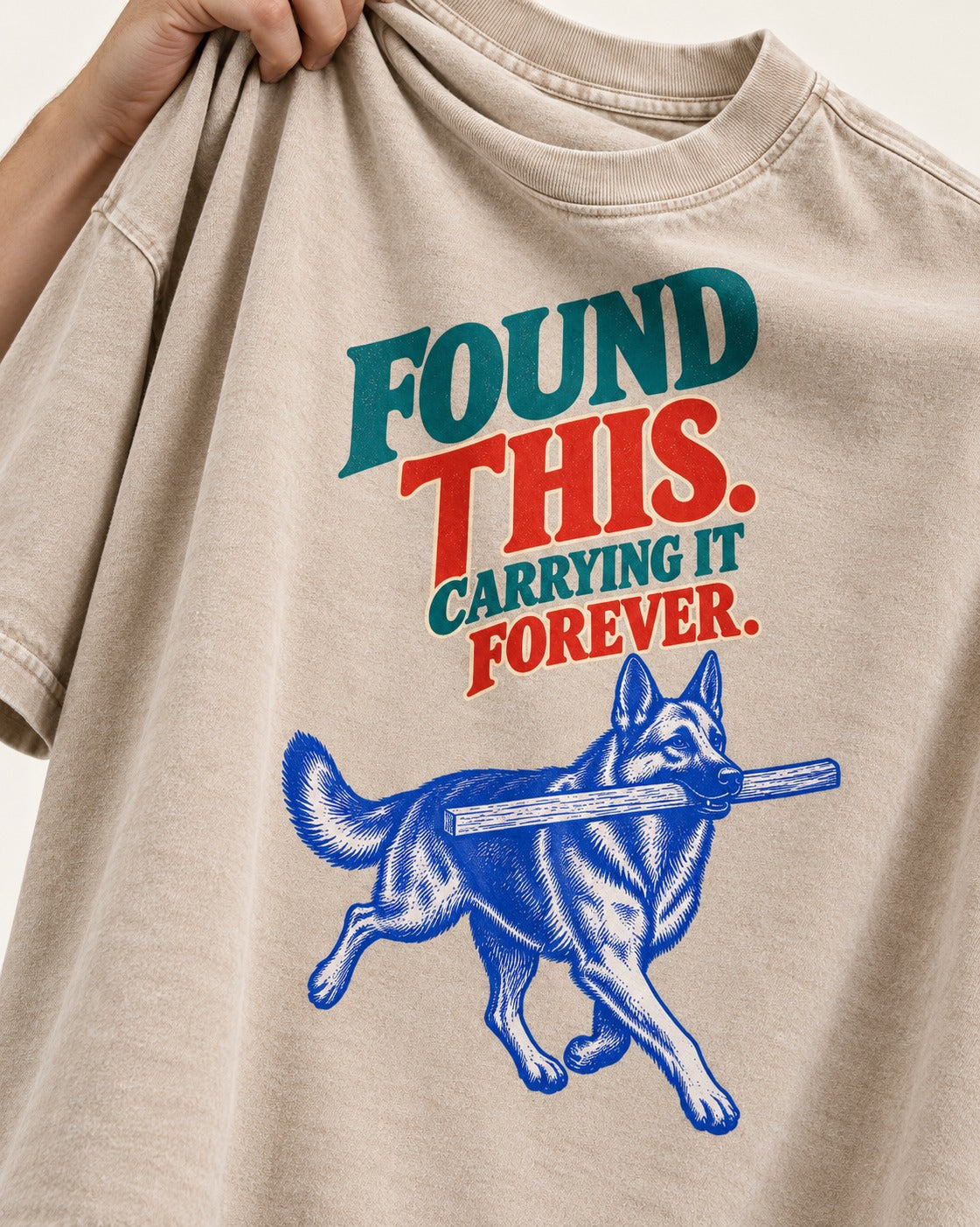 German Shepherd Dog Carrying It Forever Washed Tee in Apricot, close-up of the graphic