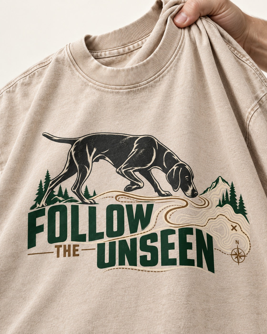Follow the Unseen German Shorthaired Pointer Washed Tee in Apricot, close-up of the graphic