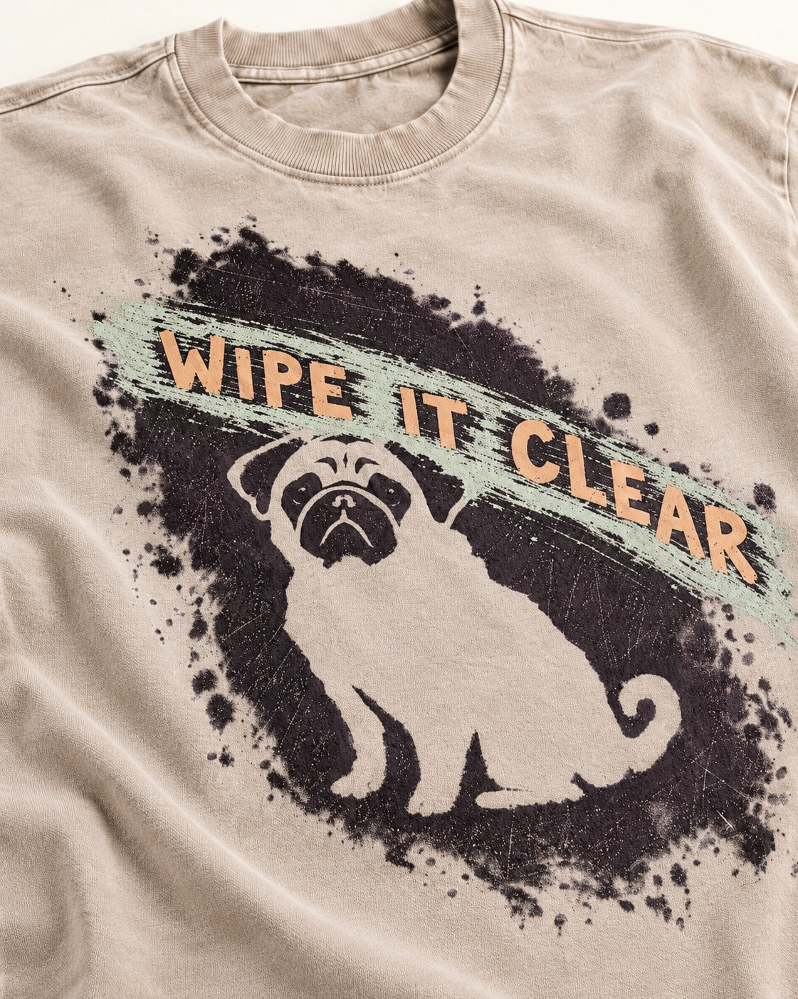 Pug Wipe It Clear Washed Tee in Apricot, close-up of the graphic