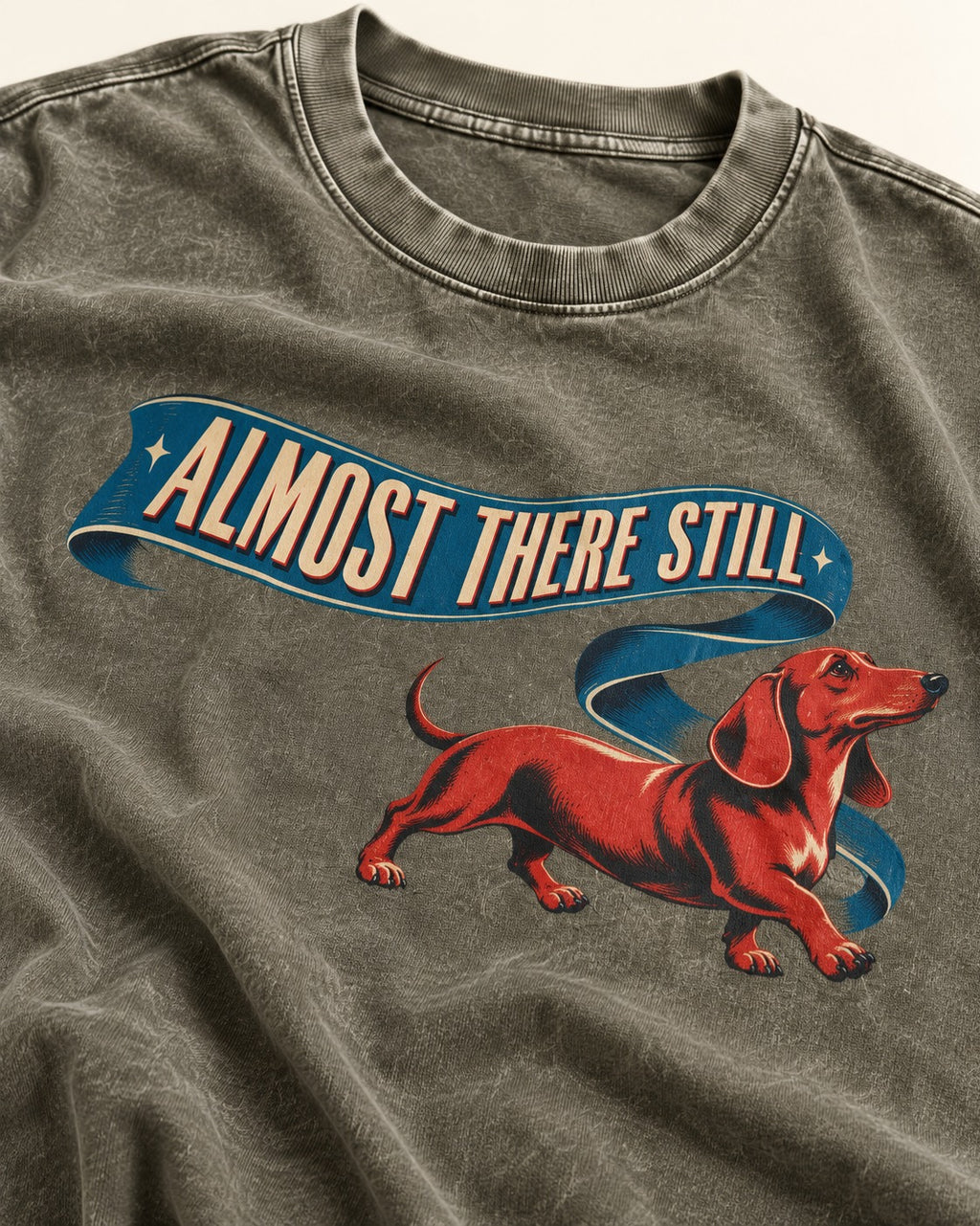 Dachshund Almost There Still Ribbon Graphic Washed Tee in Army Green, close-up of the graphic