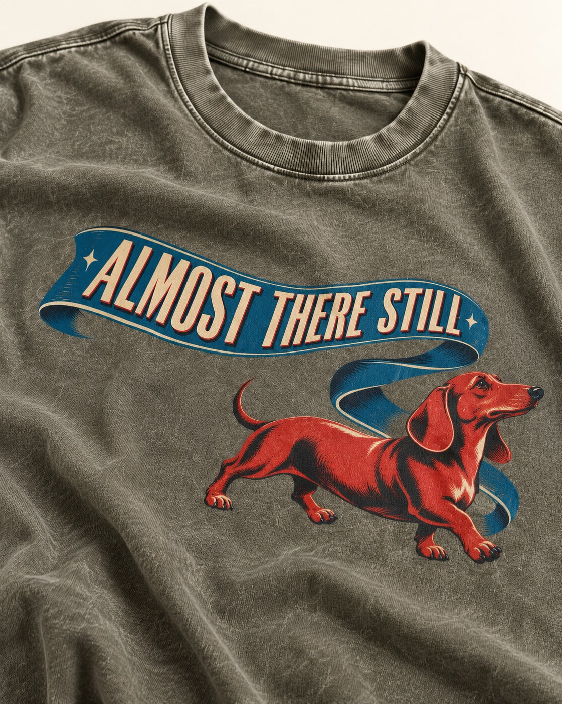 Dachshund Almost There Still Ribbon Graphic Washed Tee in Army Green, close-up of the graphic