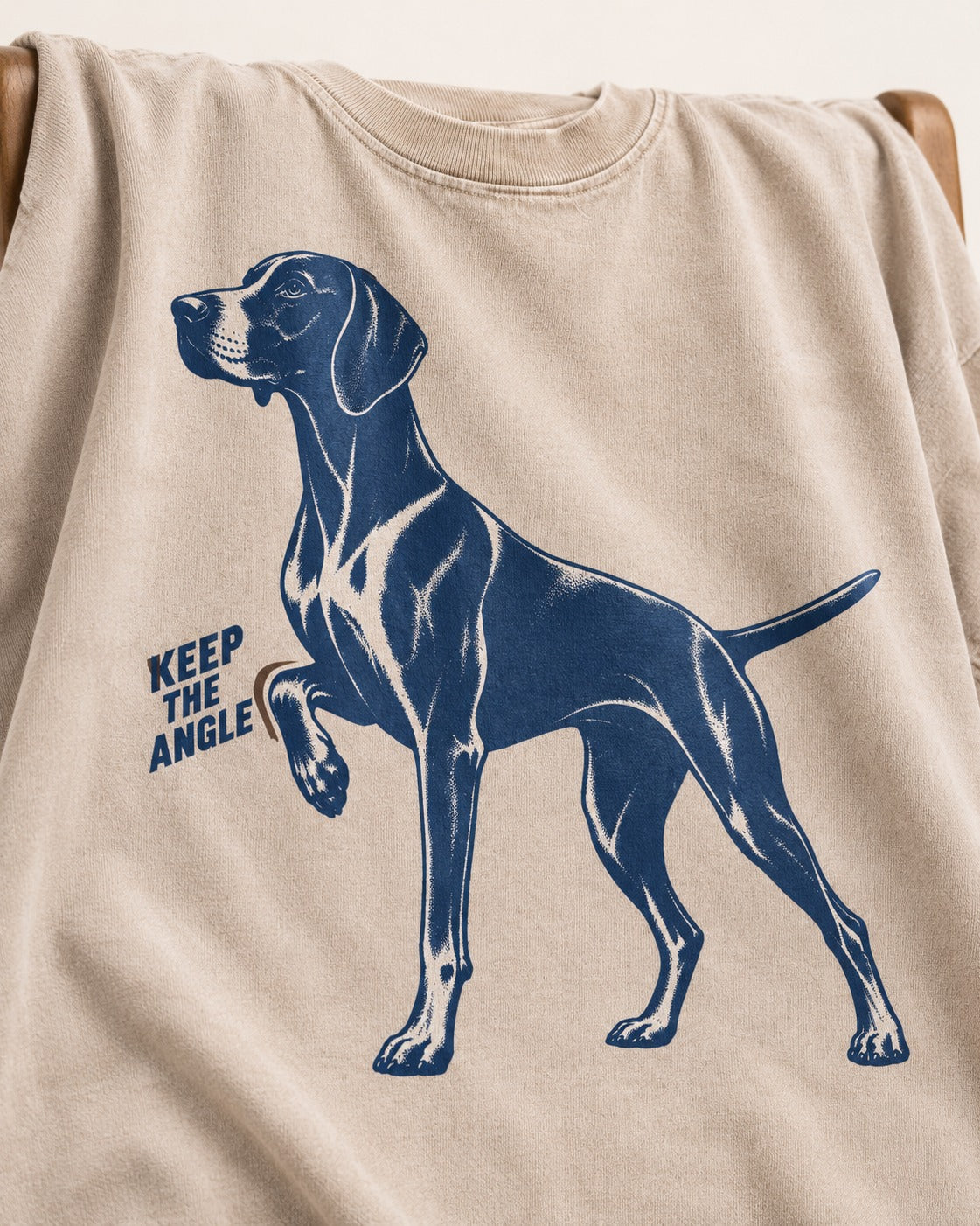 Keep the Angle German Shorthaired Pointer Washed Tee in Apricot, close-up of the graphic