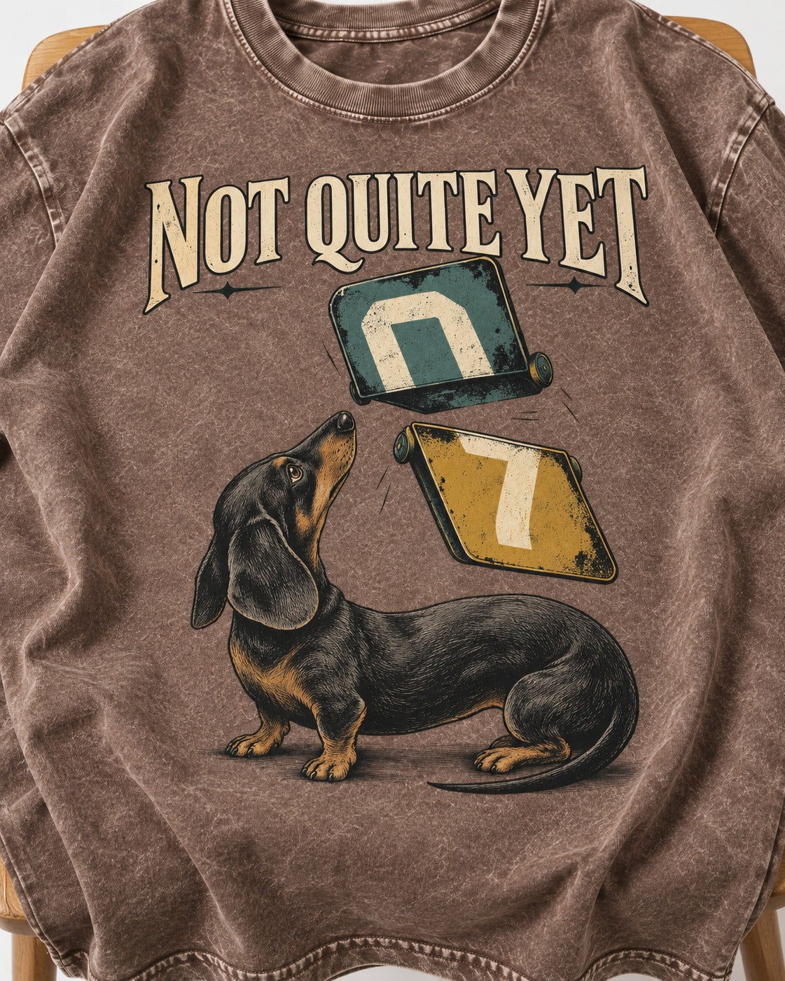 Not Quite Yet Dachshund Washed Tee in Coffee, close-up of the graphic