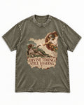 German Shorthaired Pointer Divine Timing Still Loading Creation Scene Graphic Washed Tee in Army Green, flat lay product photo