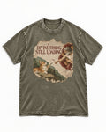 Corgi Divine Timing Still Loading Creation Parody Washed Tee in Army Green, flat lay product photo