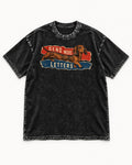 Dachshund Send More Letters Torn Paper Graphic Washed Tee in Black, flat lay product photo