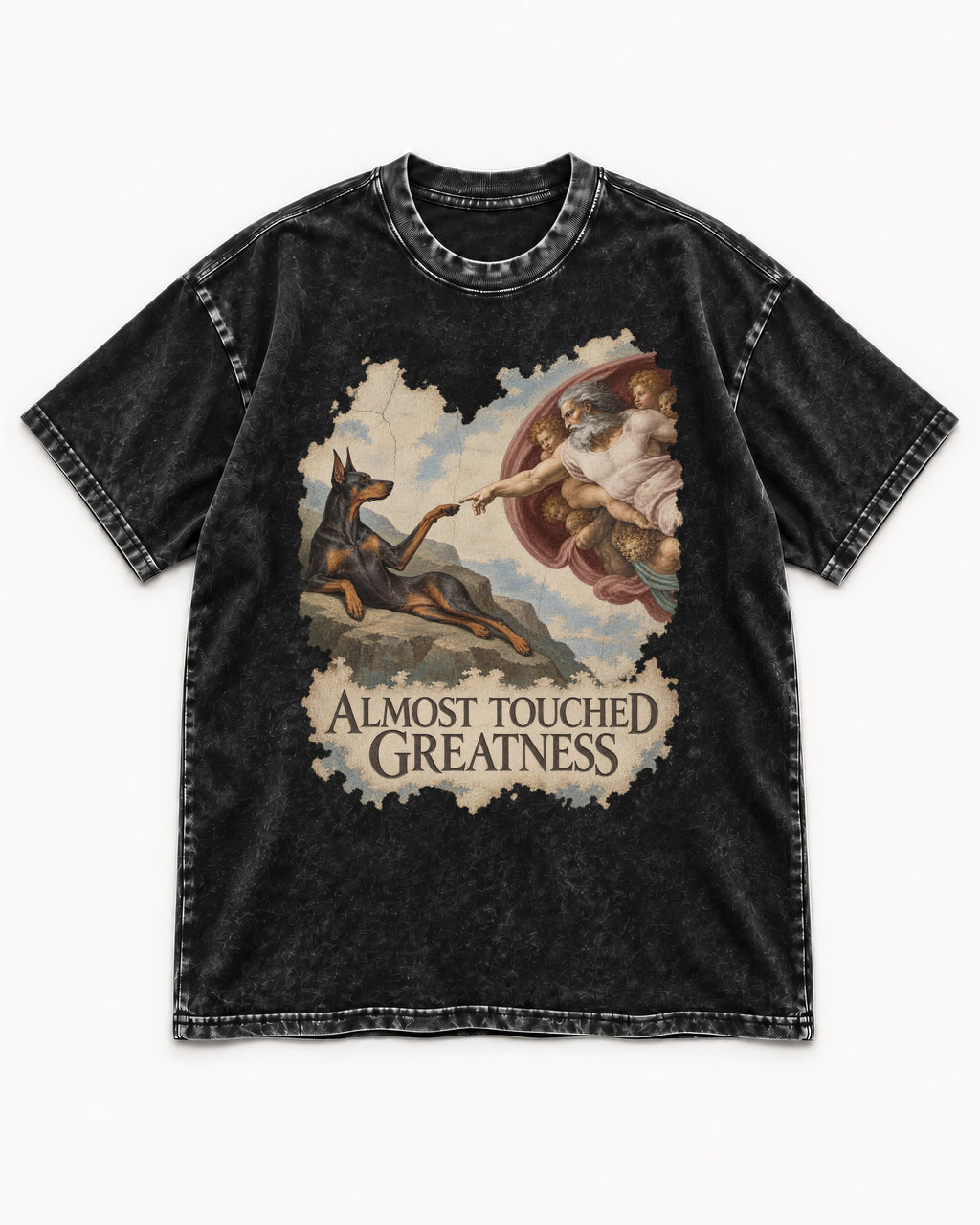 Doberman Almost Touched Greatness Creation Scene Graphic Washed Tee in Black, flat lay product photo