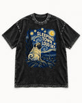 Pug Sleeping Town Loud Sky Starry Night Graphic Washed Tee in Black, flat lay product photo