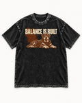 Rottweiler Balance Is Built Resting Strength Graphic Washed Tee in Black, flat lay product photo