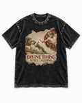 Shih Tzu Divine Timing Still Loading Renaissance Parody Graphic Washed Tee in Black, flat lay product photo